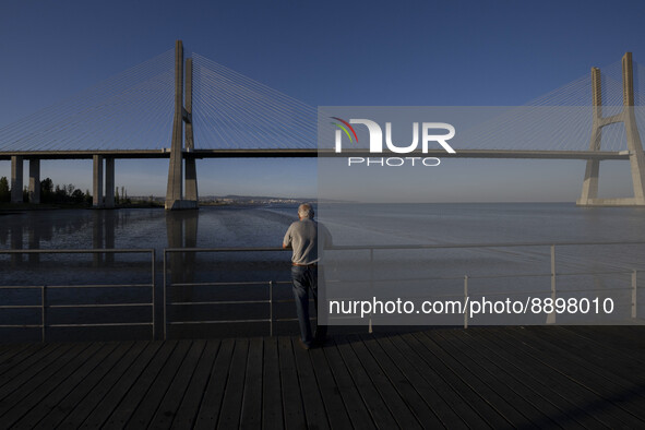 A person is seen looking at the Vasco da Gama bridge from one of the harbors in the Tejo river. Lisbon, September 22, 2022. 