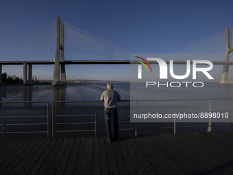 A person is seen looking at the Vasco da Gama bridge from one of the harbors in the Tejo river. Lisbon, September 22, 2022. (