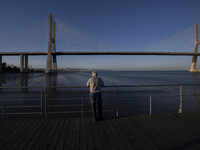 A person is seen looking at the Vasco da Gama bridge from one of the harbors in the Tejo river. Lisbon, September 22, 2022. (