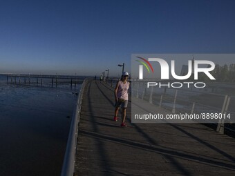 People are seen walking around the walkway of the Vasco da Gama bridge, Lisbon. September 22, 2022. (