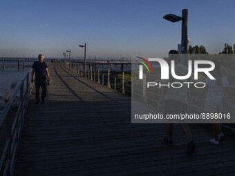 People are seen walking around the walkway of the Vasco da Gama bridge, Lisbon. September 22, 2022. (