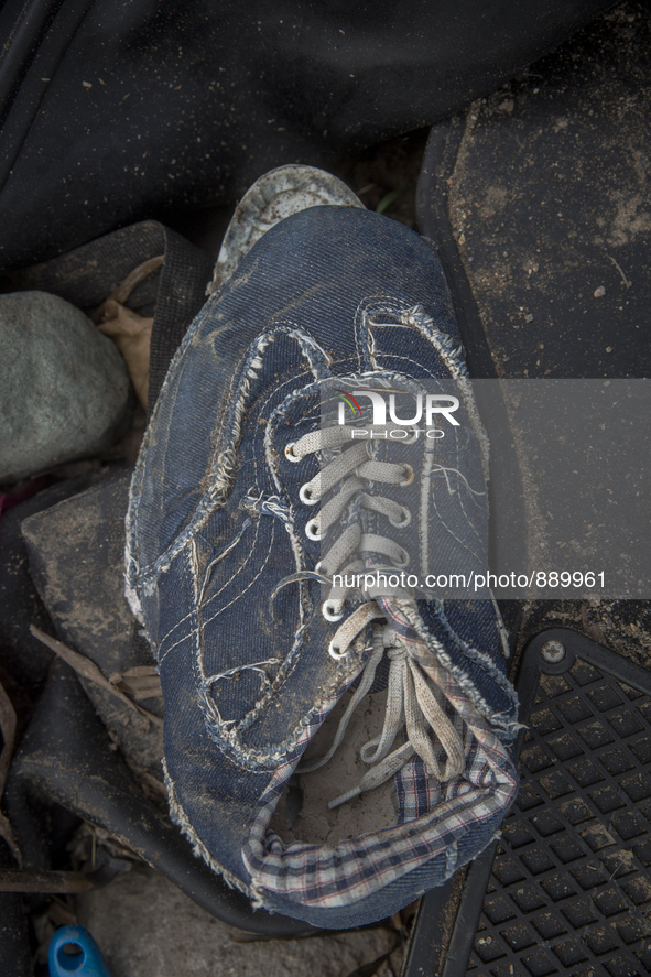 Men's denim sneaker with plaid lining found near Eftalou on the island of Lesbos.  Shoes found on the beaches and around the Greek island wh...