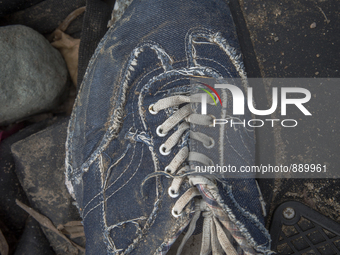 Men's denim sneaker with plaid lining found near Eftalou on the island of Lesbos.  Shoes found on the beaches and around the Greek island wh...