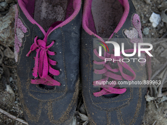 Women's sneakers with pink laces found near Eftalou on the island of Lesbos.  Shoes found on the beaches and around the Greek island where t...