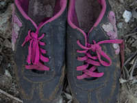 Women's sneakers with pink laces found near Eftalou on the island of Lesbos.  Shoes found on the beaches and around the Greek island where t...