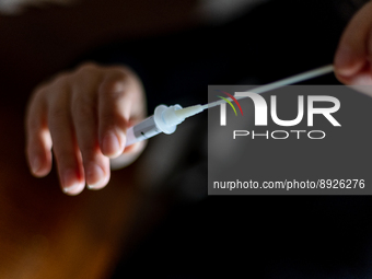 A citizen uses COVID-19 antigen self-testing kit in L’Aquila, Italy, on September 29, 2022.  (