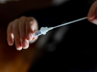 A citizen uses COVID-19 antigen self-testing kit in L’Aquila, Italy, on September 29, 2022.  (