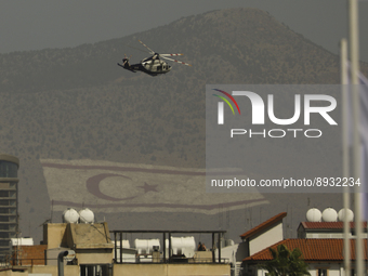 A police helicopter flies over a military parade celebrating the 61st anniversary of Cyprus' independence from British colonial rule, agains...