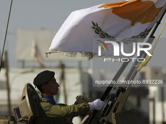 A soldier in an armored personnel carrier with the image of the Cypriot flag during the annual military parade to mark the Independence Day...