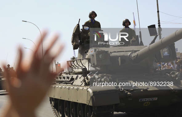 A woman applauds Cypriot soldiers who ride tanks during a military parade to celebrate Independence in Nicosia on the divided island of Cypr...