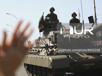 A woman applauds Cypriot soldiers who ride tanks during a military parade to celebrate Independence in Nicosia on the divided island of Cypr...