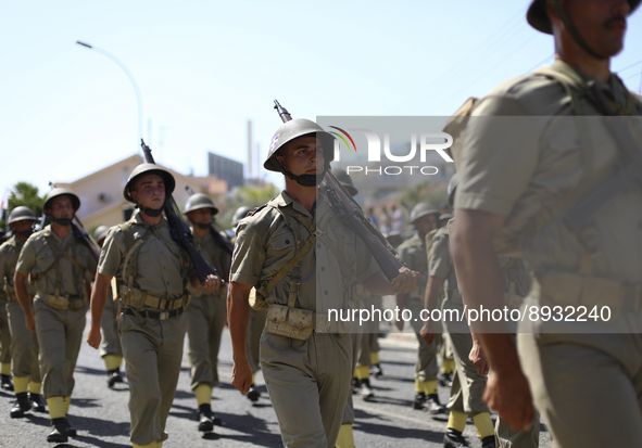 Soldiers march in a military parade marking the 61st anniversary of Cyprus' independence from British colonial rule in Nicosia on the divide...