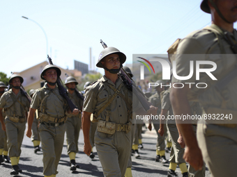 Soldiers march in a military parade marking the 61st anniversary of Cyprus' independence from British colonial rule in Nicosia on the divide...