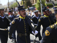 Soldiers march in a military parade marking the 61st anniversary of Cyprus' independence from British colonial rule in Nicosia on the divide...