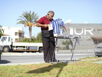 A man sells the national flags of Greece and Cyprus before the start of a military parade to mark the 61st anniversary of the independence o...