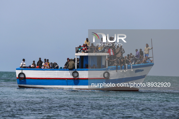 A small sailboat crowded with nearly 118 people. 