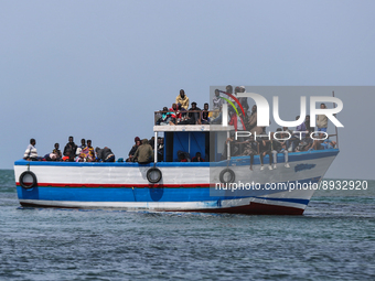 A small sailboat crowded with nearly 118 people. (