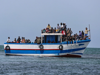 A small sailboat crowded with nearly 118 people. (