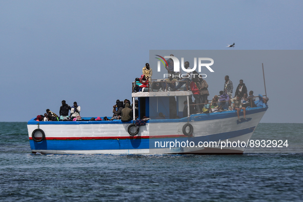 A small sailboat crowded with nearly 118 people 