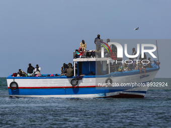 A small sailboat crowded with nearly 118 people (