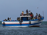 A small sailboat crowded with nearly 118 people (