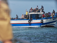 A small sailboat crowded with nearly 118 people (