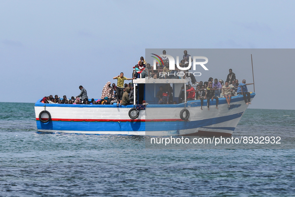 A small sailboat crowded with nearly 118 people 