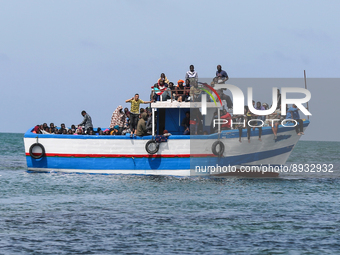 A small sailboat crowded with nearly 118 people (