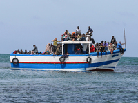 A small sailboat crowded with nearly 118 people (