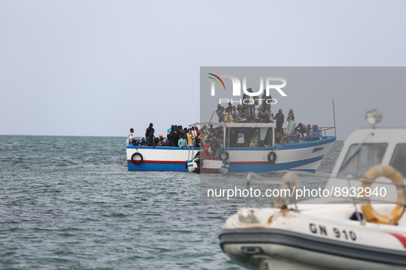 A small sailboat crowded with nearly 118 people and a unity of Tunisian guards coast watch them 