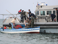 Transfer of the migrant from the fish boat to the unity of the Tunisian army ship. (