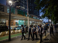 People wear protective face masks walk in business district on the main street in Jakarta on 3 October 2022. President Joko Widodo mentioned...