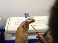 A person prepares a influenza vaccine during  the national influenza vaccination campaign at the Specialty Clinic. on October 3, 2022 in Mex...