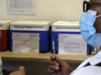 A person prepares a influenza vaccine during  the national influenza vaccination campaign at the Specialty Clinic. on October 3, 2022 in Mex...