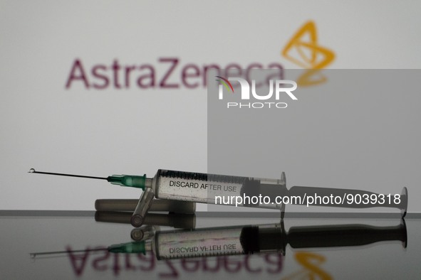 In this photo illustration a covid-19 vaccine is seen with the AstraZeneca logo in the background. (Photo Illustration by Nikos Pekiaridis/N...