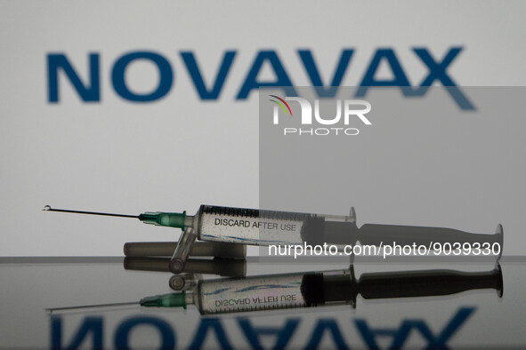 In this photo illustration a covid-19 vaccine is seen with the Novavax logo in the background. (Photo Illustration by Nikos Pekiaridis/NurPh...