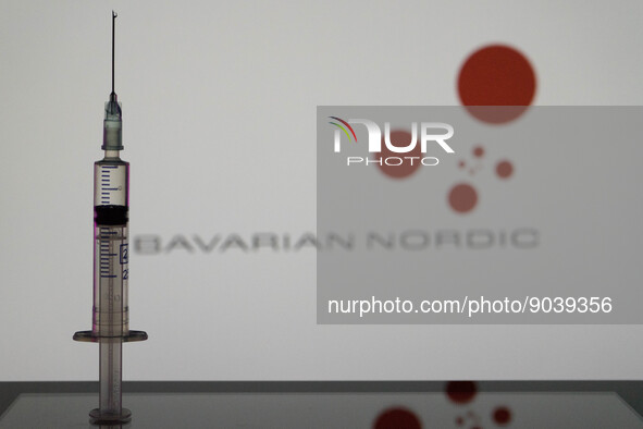 In this photo illustration a vaccine is seen in front of a screen with the Bavarian Nordic logo. (Photo Illustration by Nikos Pekiaridis/Nur...