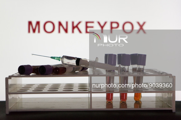 In this photo illustration blood test vials and a vaccine are seen in front of a screen that says "Monkeypox". (Photo Illustration by Nikos...