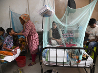 Children are kept inside mosquito nets as they are hospitalized due to dengue fever at Dhaka Child Hospital in Dhaka, Bangladesh on October...