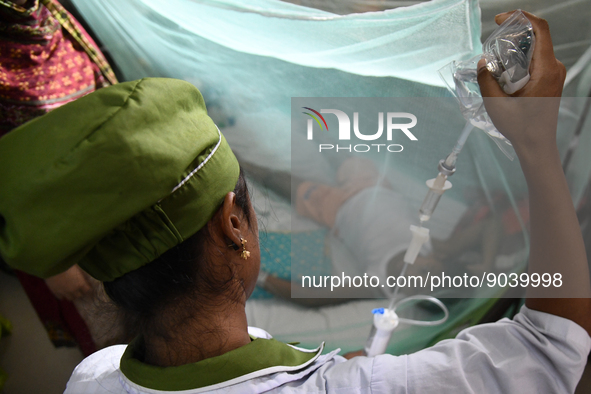 A Health worker gives treatment to a dengue-infected child at Dhaka Child Hospital in Dhaka, Bangladesh on October 19, 2022.  Bangladesh log...