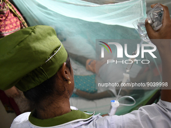 A Health worker gives treatment to a dengue-infected child at Dhaka Child Hospital in Dhaka, Bangladesh on October 19, 2022.  Bangladesh log...