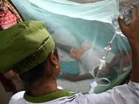 A Health worker gives treatment to a dengue-infected child at Dhaka Child Hospital in Dhaka, Bangladesh on October 19, 2022.  Bangladesh log...