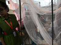 Children are kept inside mosquito nets as they are hospitalized due to dengue fever at Dhaka Child Hospital in Dhaka, Bangladesh on October...