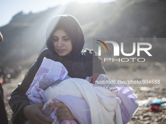 A woman from Syria embraces her son as refugees and migrants riding a dinghy reach the shores of the Greek island of Lesbos after crossing t...