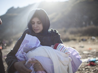 A woman from Syria embraces her son as refugees and migrants riding a dinghy reach the shores of the Greek island of Lesbos after crossing t...