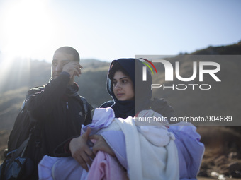 A woman from Syria embraces her son as refugees and migrants riding a dinghy reach the shores of the Greek island of Lesbos after crossing t...