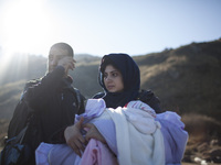 A woman from Syria embraces her son as refugees and migrants riding a dinghy reach the shores of the Greek island of Lesbos after crossing t...