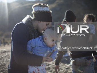 A woman from Syria embraces her son as refugees and migrants riding a dinghy reach the shores of the Greek island of Lesbos after crossing t...