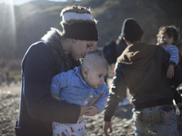 A woman from Syria embraces her son as refugees and migrants riding a dinghy reach the shores of the Greek island of Lesbos after crossing t...