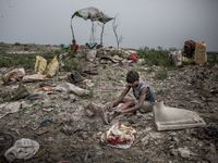 A scavenger is sorting out the metal wastes. Dhapa, Kolkata, India. January 20, 2015. *** Go to http://nurphoto.com/en/reportages/51696 to s...